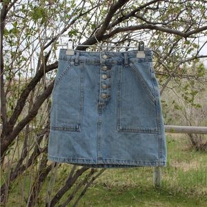 Light blue denim skirt with buttons up the top.